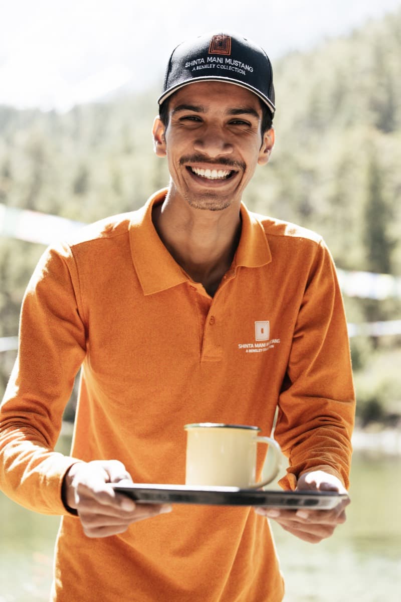 A host carrying refreshments on a terrace