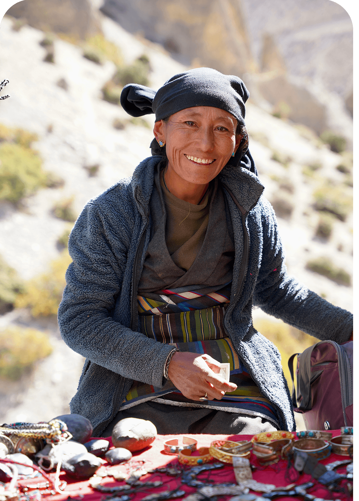 Woman selling handmade jewellery at a mountain market stall