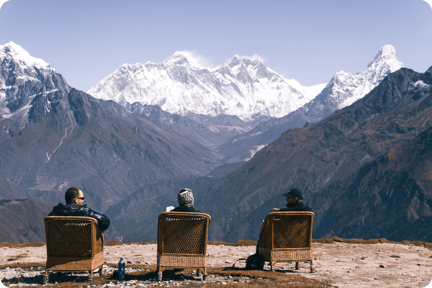 Guests seated overlooking snow-capped peaks