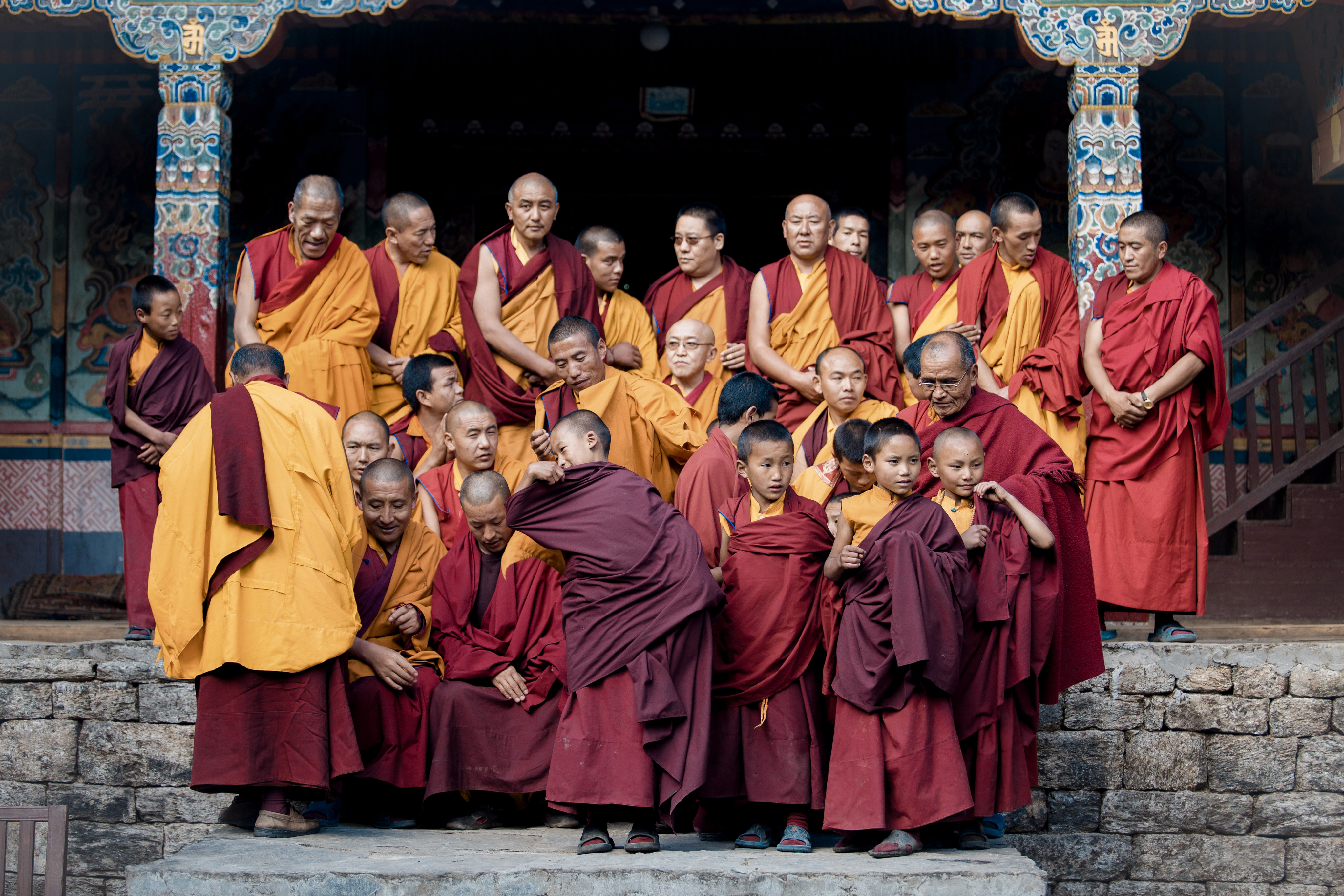 Monks gathered on temple steps in traditional robes